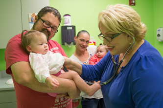 A doctor checks a baby's foot