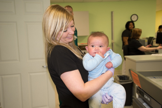 A nurse holds a baby