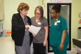 A doctor checks a patients' pulse