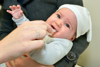 A happy baby being cradled